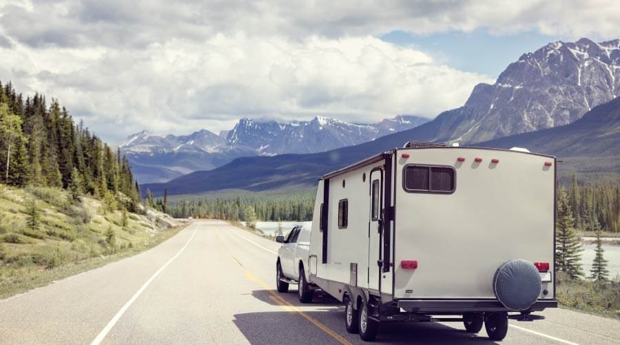 rv trailer on road mountains