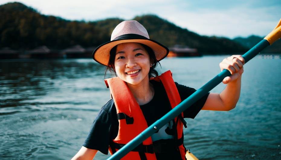 young asian female kayaking